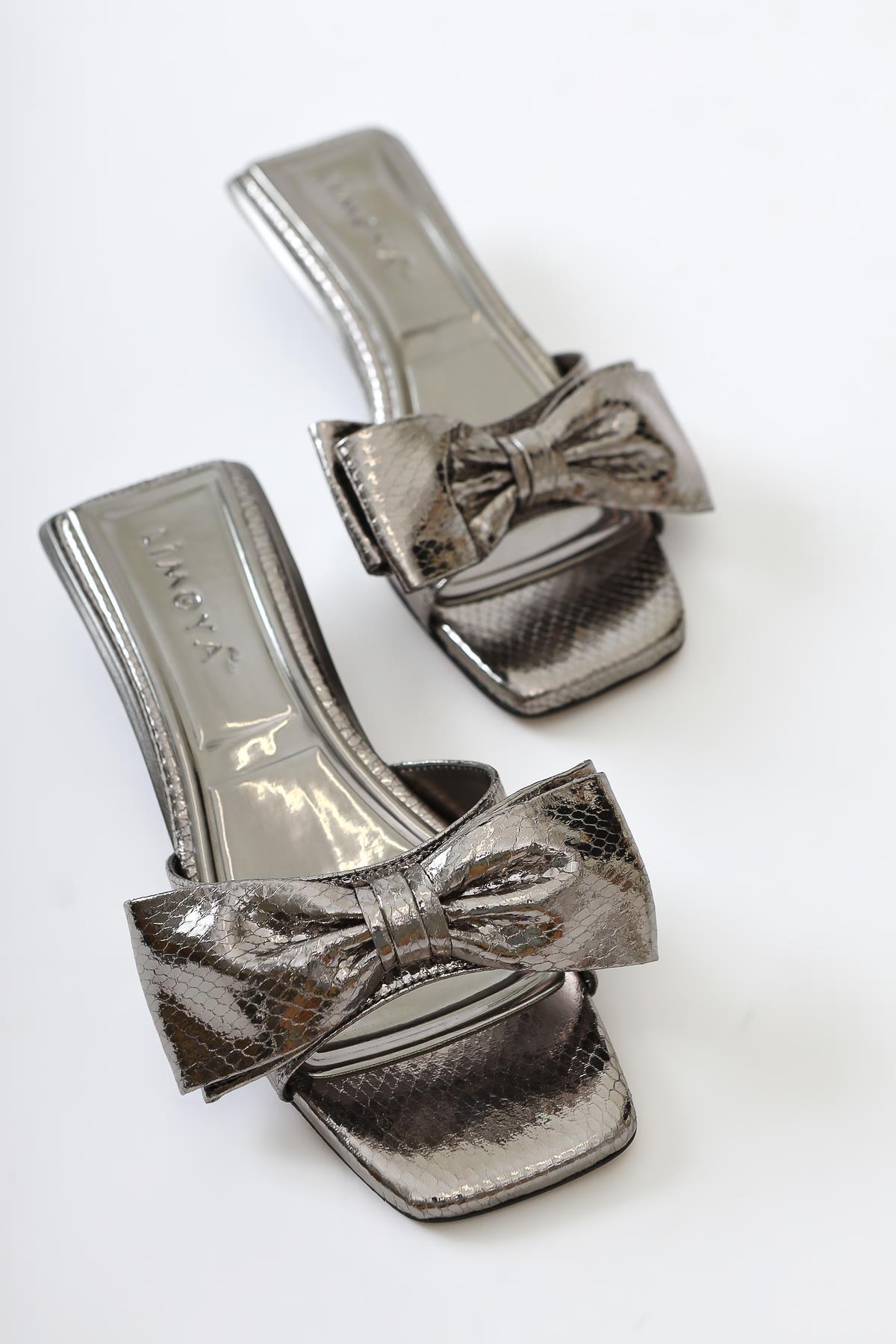 Juvy Glossy Platinum Snake Skin Textured Bow Slippers
